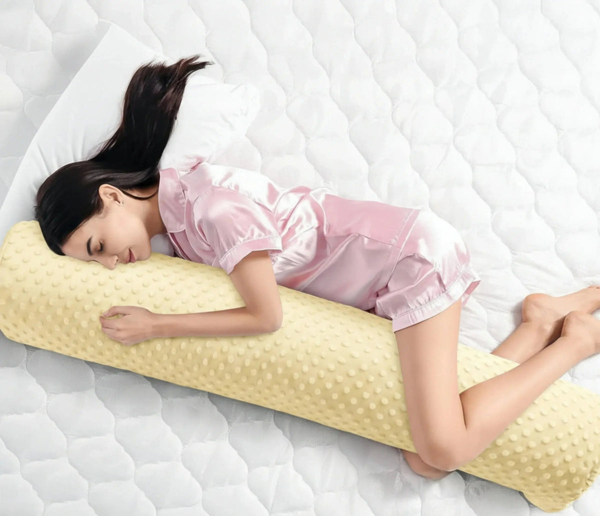 Velmesta full length body pillow in yellow bubble-dot minky, hugged by a side sleeper in bed