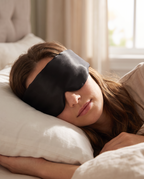 Woman sleeping wearing the Velmesta Silk Sleep Mask in black