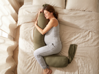 Woman side sleeping while hugging the body pillow