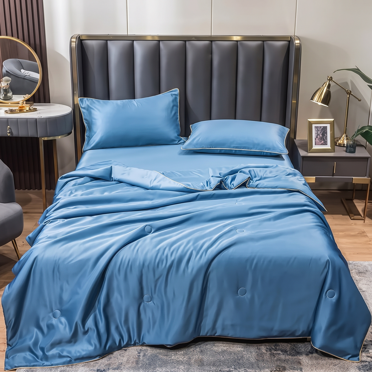 Velmesta washed silk summer quilt set in dusty blue on a neatly made bed