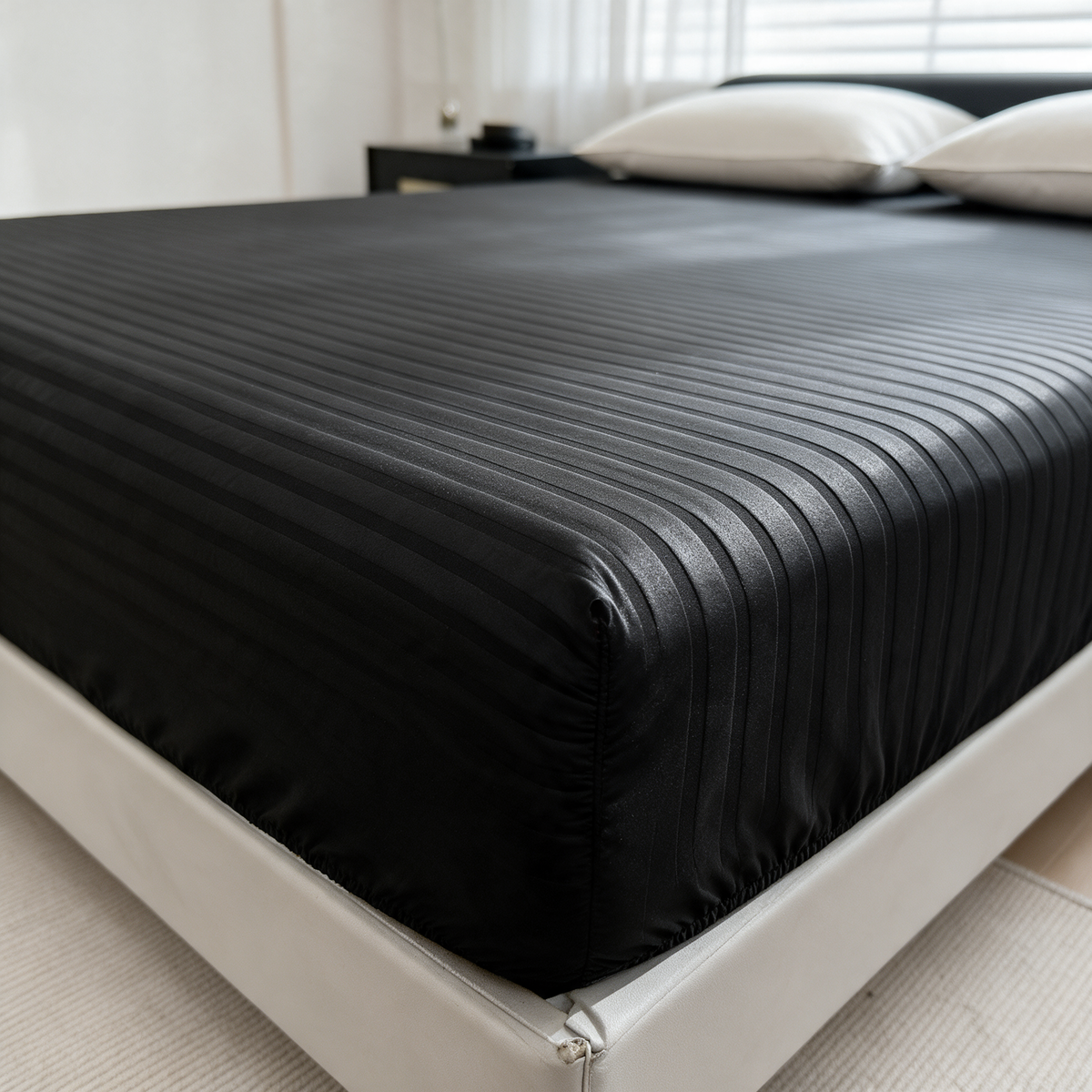 Black embossed stripe fitted sheet on a made bed